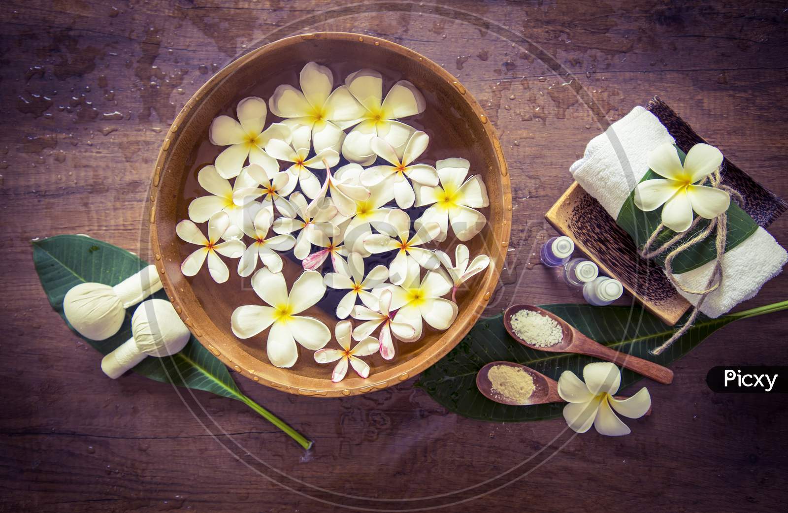 white flower in water tub with wooden background