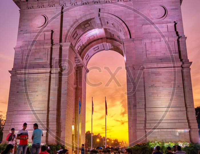 Tourists Visit The Illuminated India Gate War Memorial During Colorful Sunset, New Delhi, India