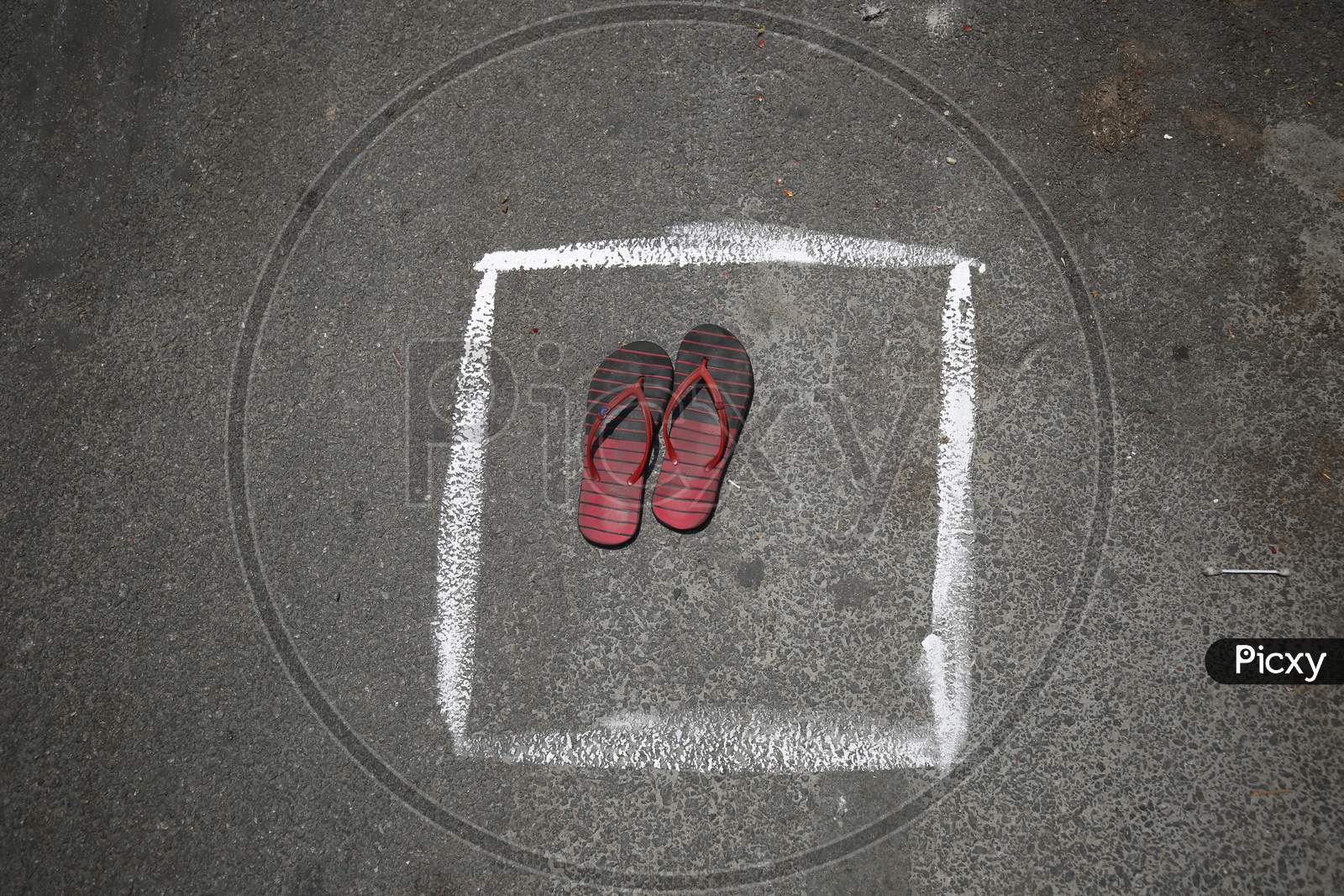 A pair of slippers is left to secure spots in a box drawn on a street to maintan social distancing during the nationwide lockdown to stop the spread of Coronavirus (COVID-19) in Bangalore, India, May 02, 2020.