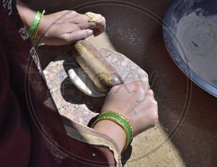 A Rural Indian Woman Preparing Chapati In Traditional Way