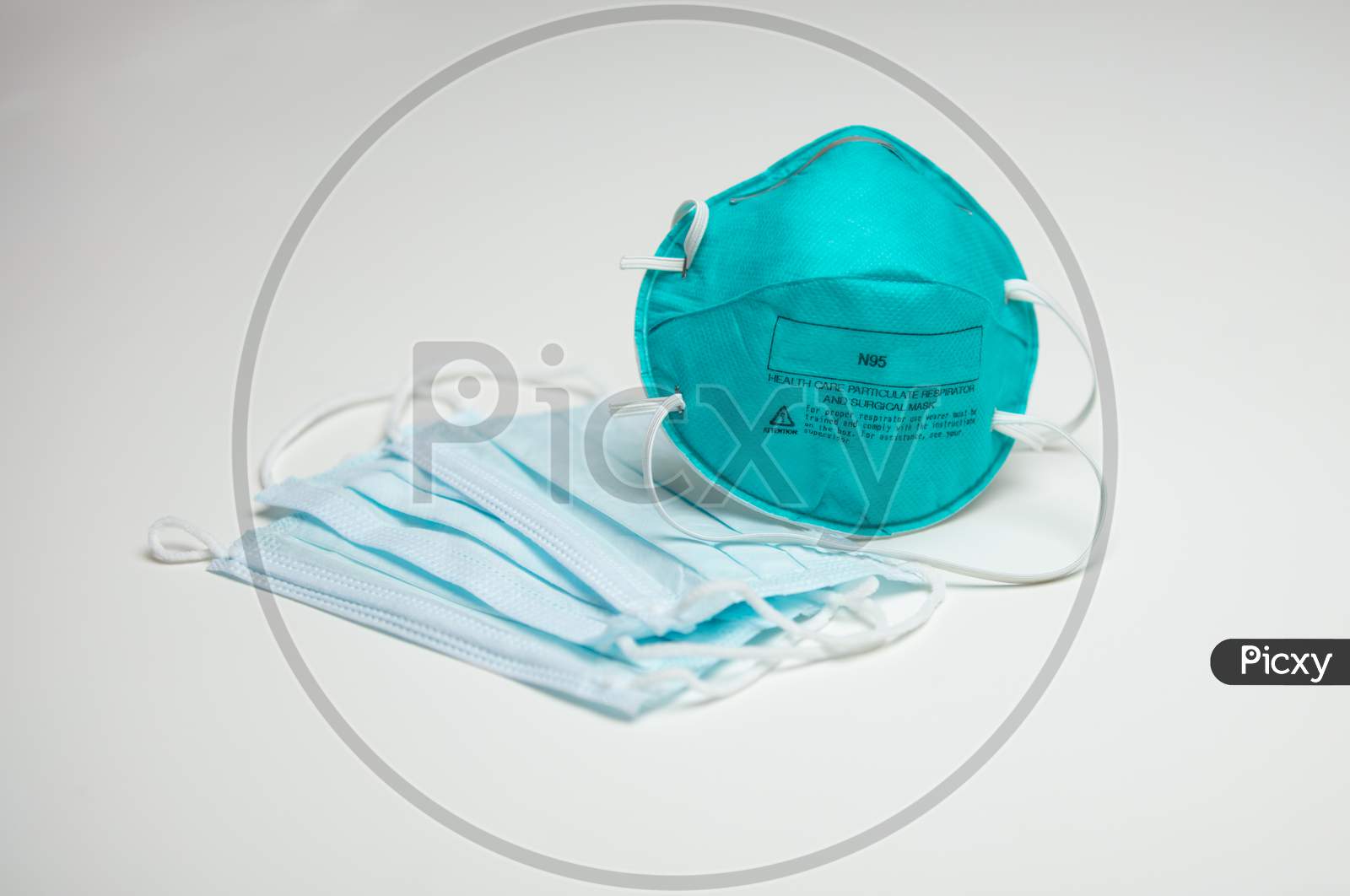 A Closeup Of An Assortment Of Protective Face Masks. One N95 And Three Surgical Masks.