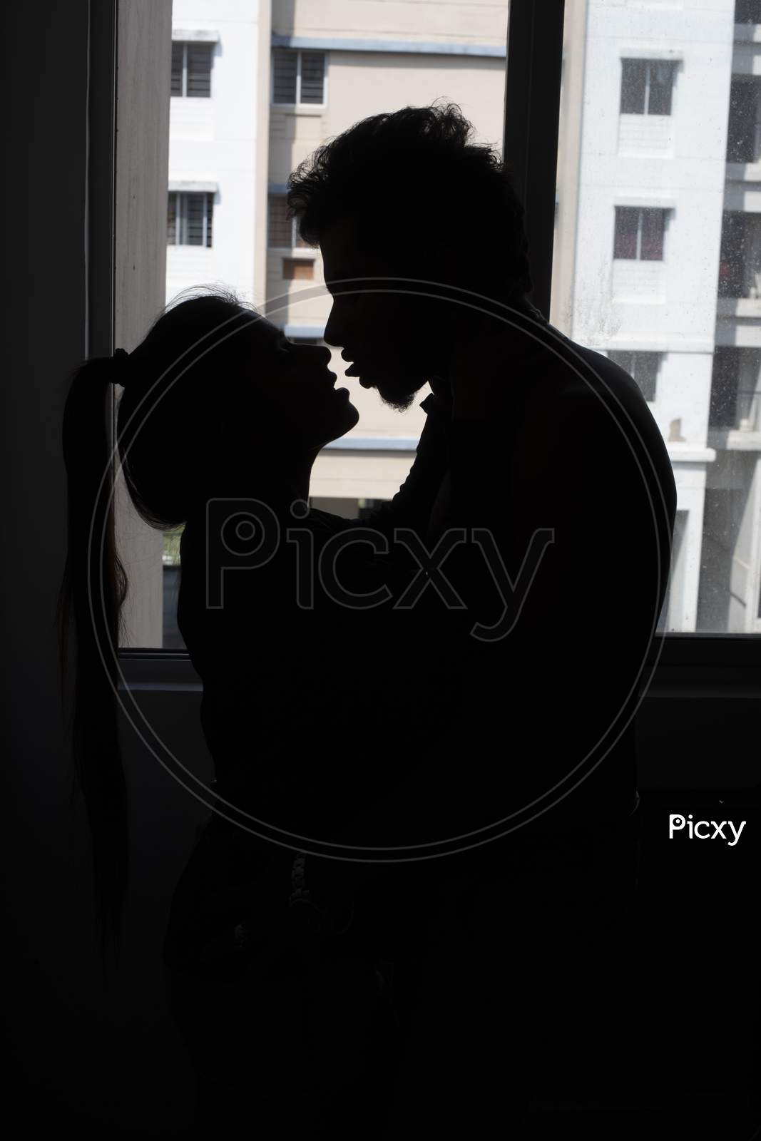 Image of Silhouette of an Indian romantic couple kissing in front ...