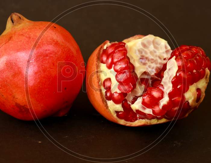Red juicy fruit pomegranates on a dark background. top view overhead view copy space