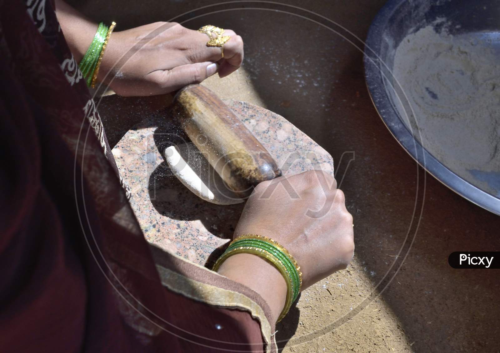 A Rural Indian Woman Preparing Chapati In Traditional Way