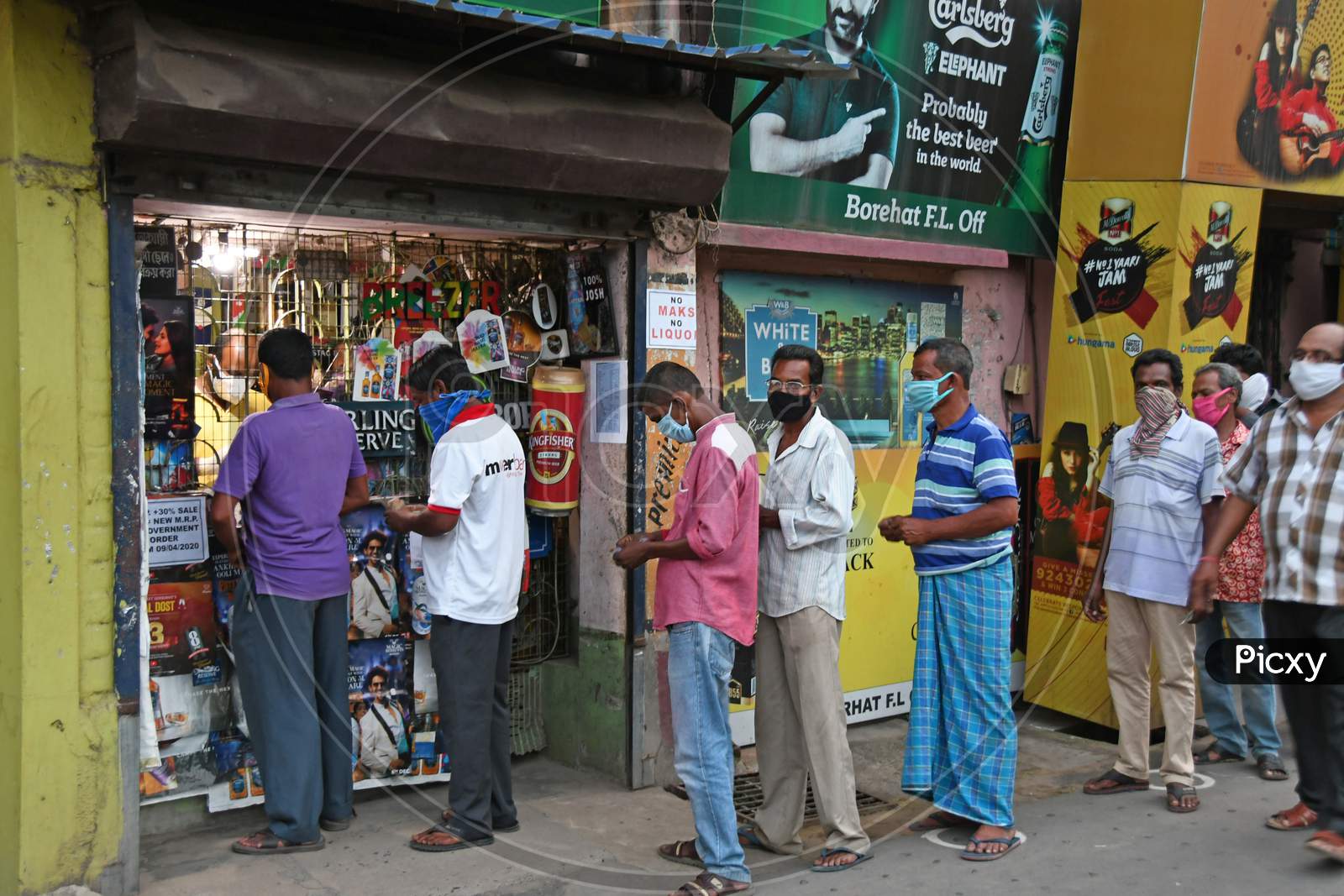 Long queues of buyers as liquor shop reopen in areas outside the containment zone after the announcement of government directives during the lockdown period due to Novel Coronavirus (COVID-19) outbreak.