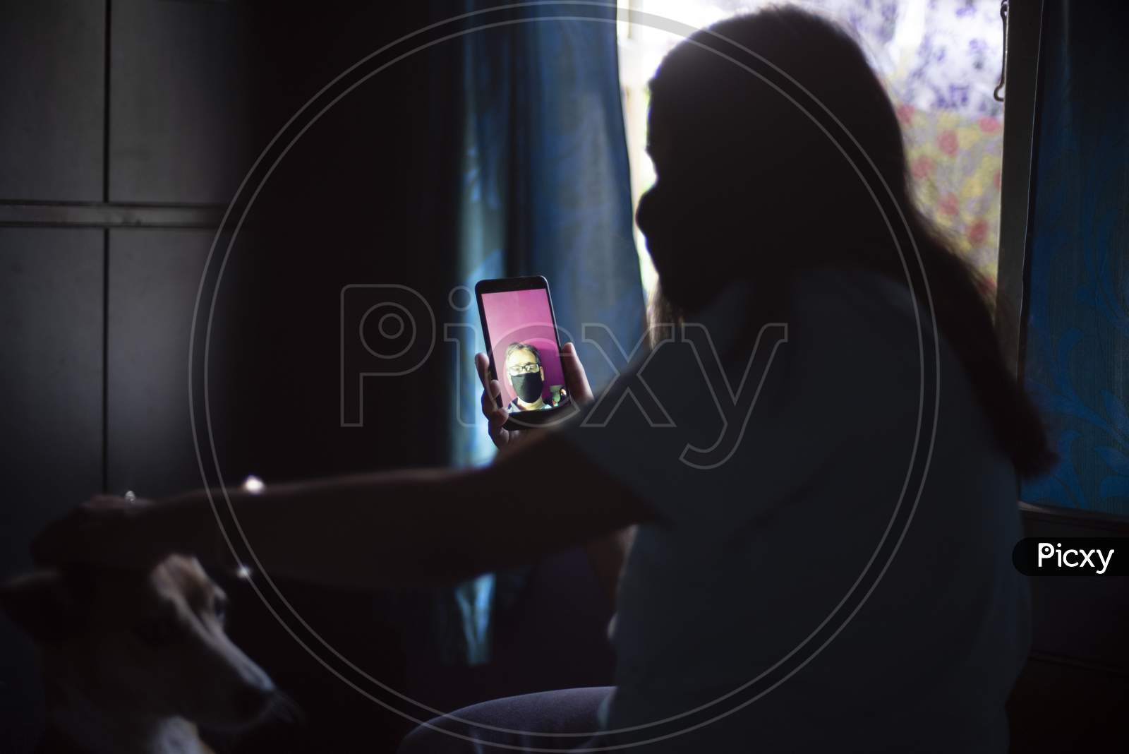 An Indian woman talking to her father in video call during lock down period. Indian lifestyle in home quarantine.