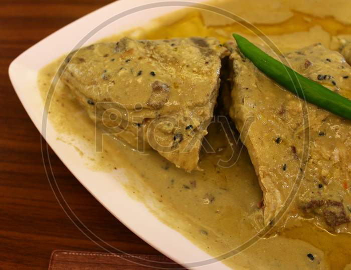 Cooked Hilsa fish and steamed rice served in a restaurant