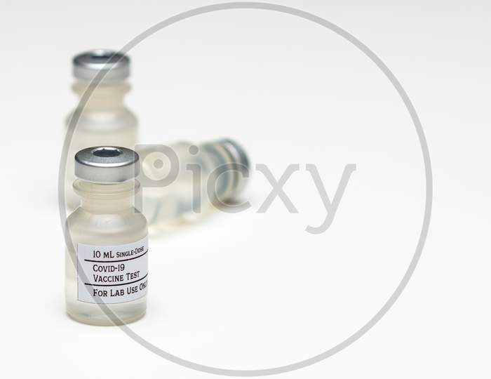 A Pair Of Covid-19 Test Vaccine Vials Isolated On A White Background.