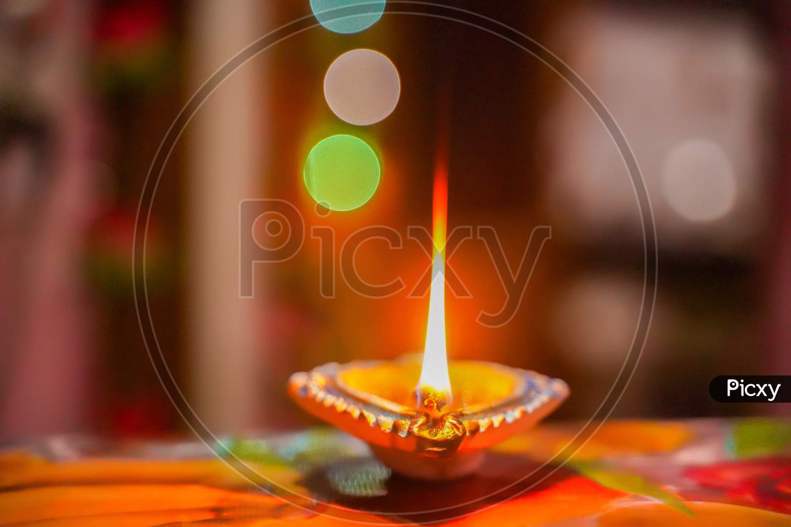 Happy Diwali - Lit diya lamp on street at night