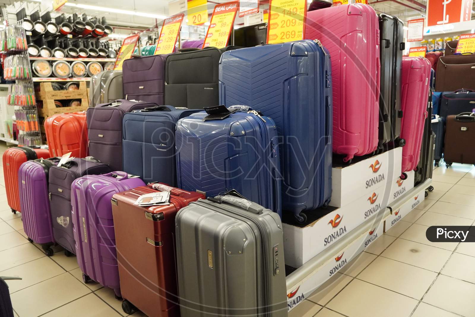 Department Store Interior View With Luggage Zone. Multicolored Suitcases In Store For Sale. Plastic And Cloth Suitcases With Discount Tags. Concept Of Black Friday Discounts India