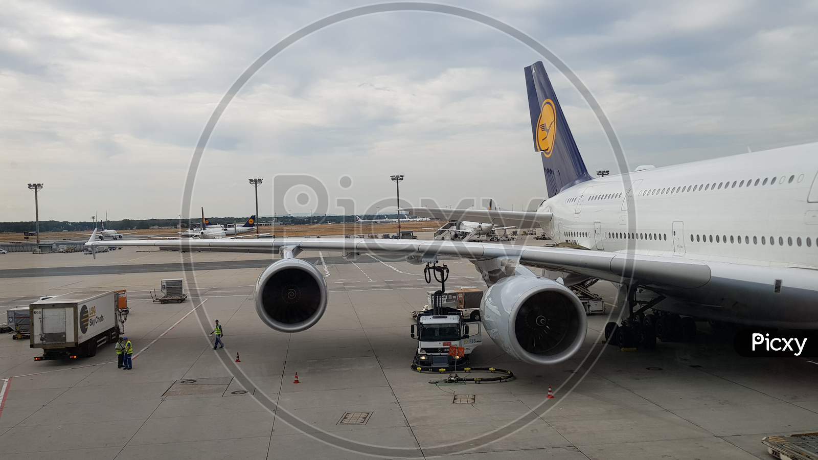 An airbus A380 aircraft getting refueled at the terminal in Frankfurt airport during day time