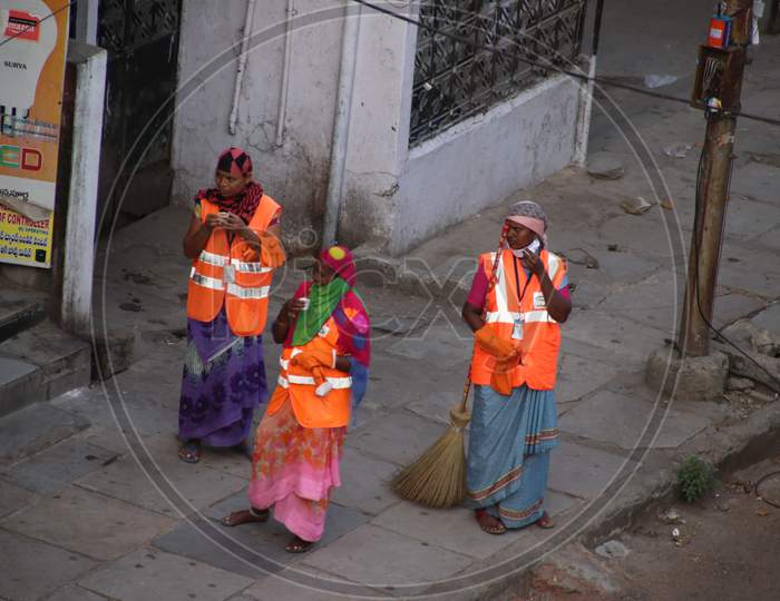 GHMC women workers taking a break during cleaning shift