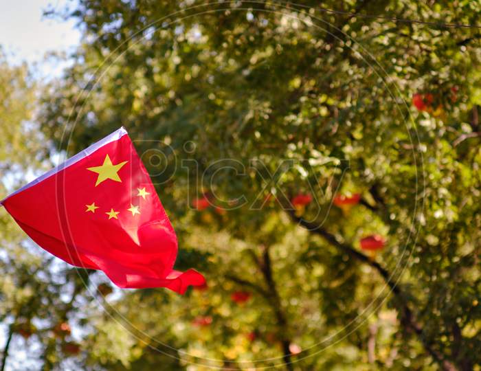 Flag Of The People'S Republic Of China, Hanging In A Park During National Day In Beijing, China