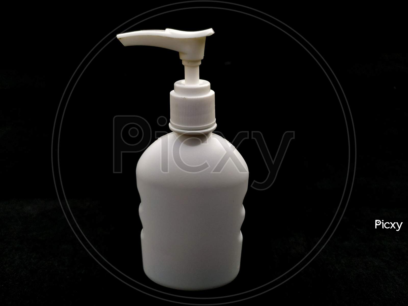 white plastic hand sanitizer bottle isolated on black background