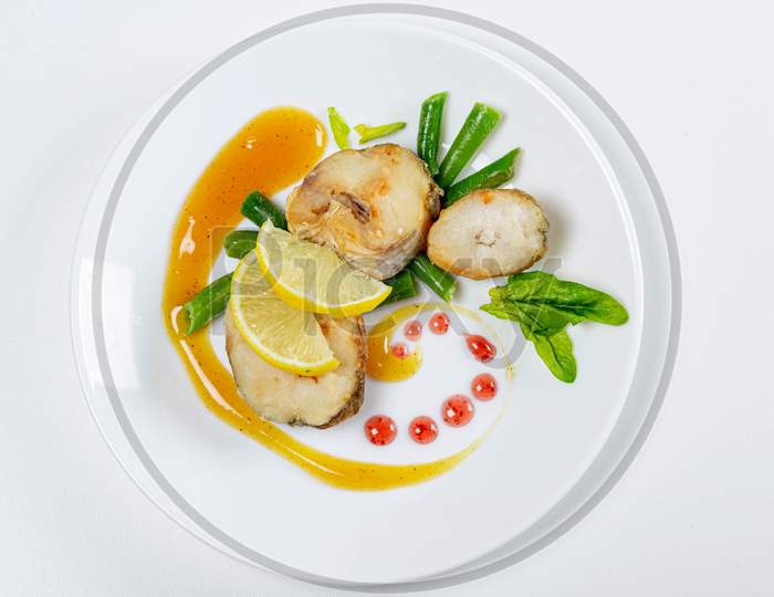 Top View Of Fish With Asparagus, Lemon And Mango Sauce
