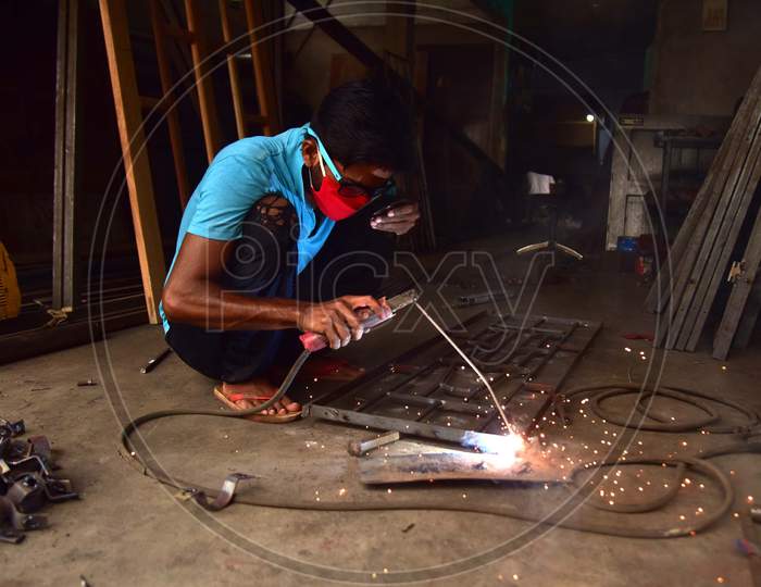 A welder works at his workshop  that was opened as per the relaxed Covid-19 or Coronavirus Nationwide Lockdown Guidelines, In Nagaon District Of Assam On  May 5, 2020.