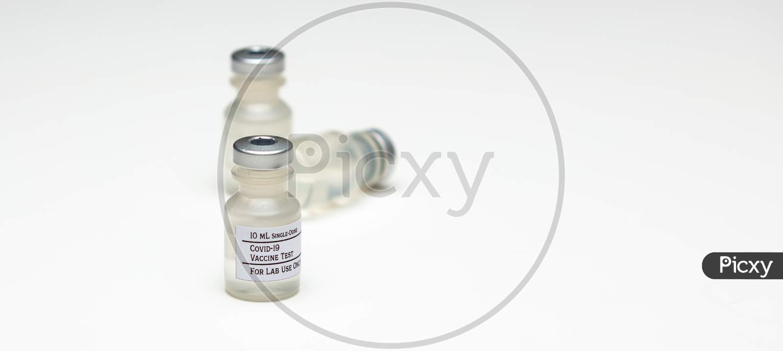 A Pair Of Covid-19 Test Vaccine Vials Isolated On A White Background.