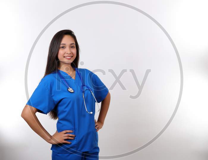 A Friendly Nurse Smiles At The Camera As She Wears Her Stethoscope Proudly.