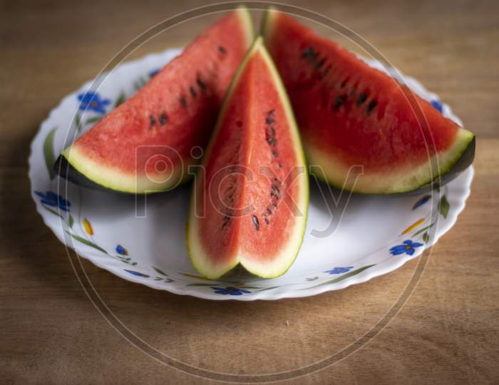 Slices Of Red Juicy Watermelon On Plate In Summer With Space For Text On Right Side