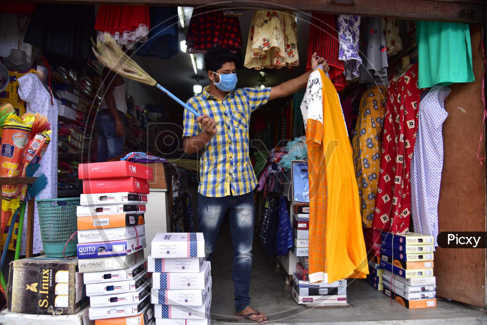 A Shopkeeper Arranges His Garments Shop That Was Opened As Per The Relaxed Covid-19 or Coronavirus Nationwide  Lockdown Guidelines, In Nagaon District Of Assam On  May 5, 2020.
