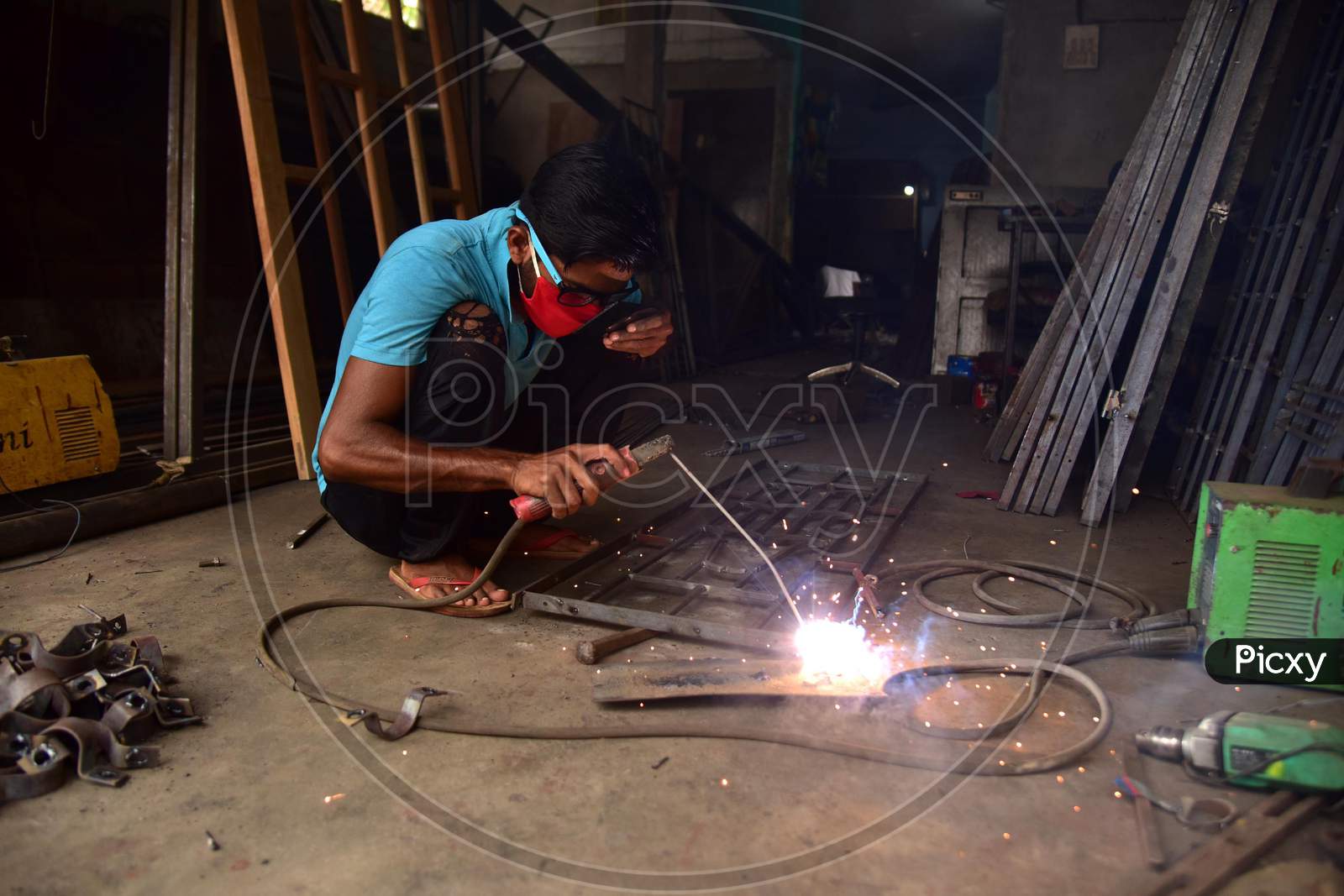 AA welder works at his workshop  that was opened as per the relaxed Covid-19 or Coronavirus Nationwide Lockdown Guidelines, In Nagaon District Of Assam On  May 5, 2020.