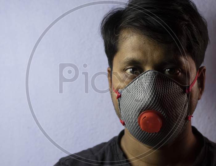 An Indian Man Wearing Safety Nose Mask Looking At Camera White Background Corona Virus Or Covid-19 Protection