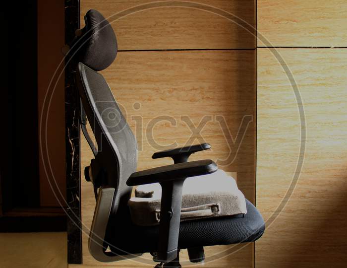 Grey Memory foam sciatica/coccyx cushion in black office chair in home