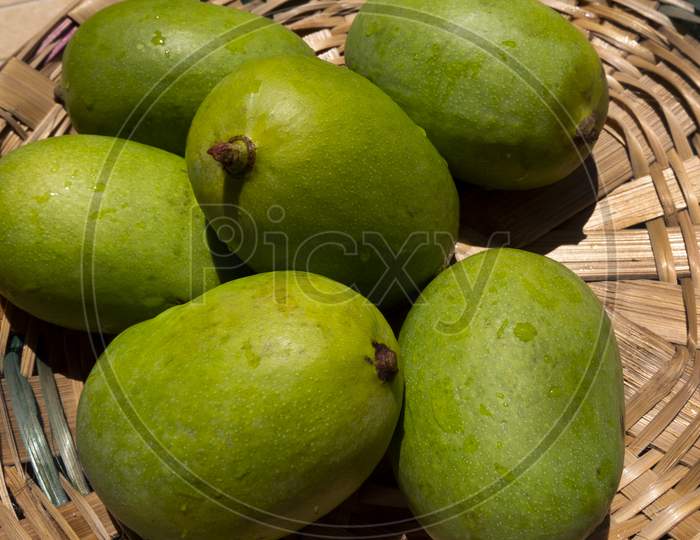 top view of raw mangoes in basket