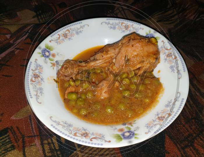 homemade Pakistani chicken curry with pea in traditional plate