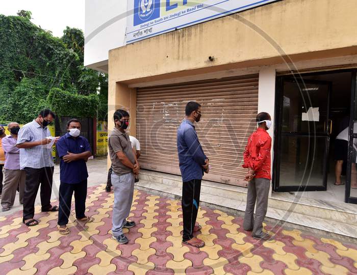 People Maintain Social Distance As They Stand In A Queue Outside LIC Office  That Was Opened As Per The Relaxed Covid-19 or Coronavirus  Lockdown Guidelines, In Nagaon District Of Assam On  May 5, 2020.