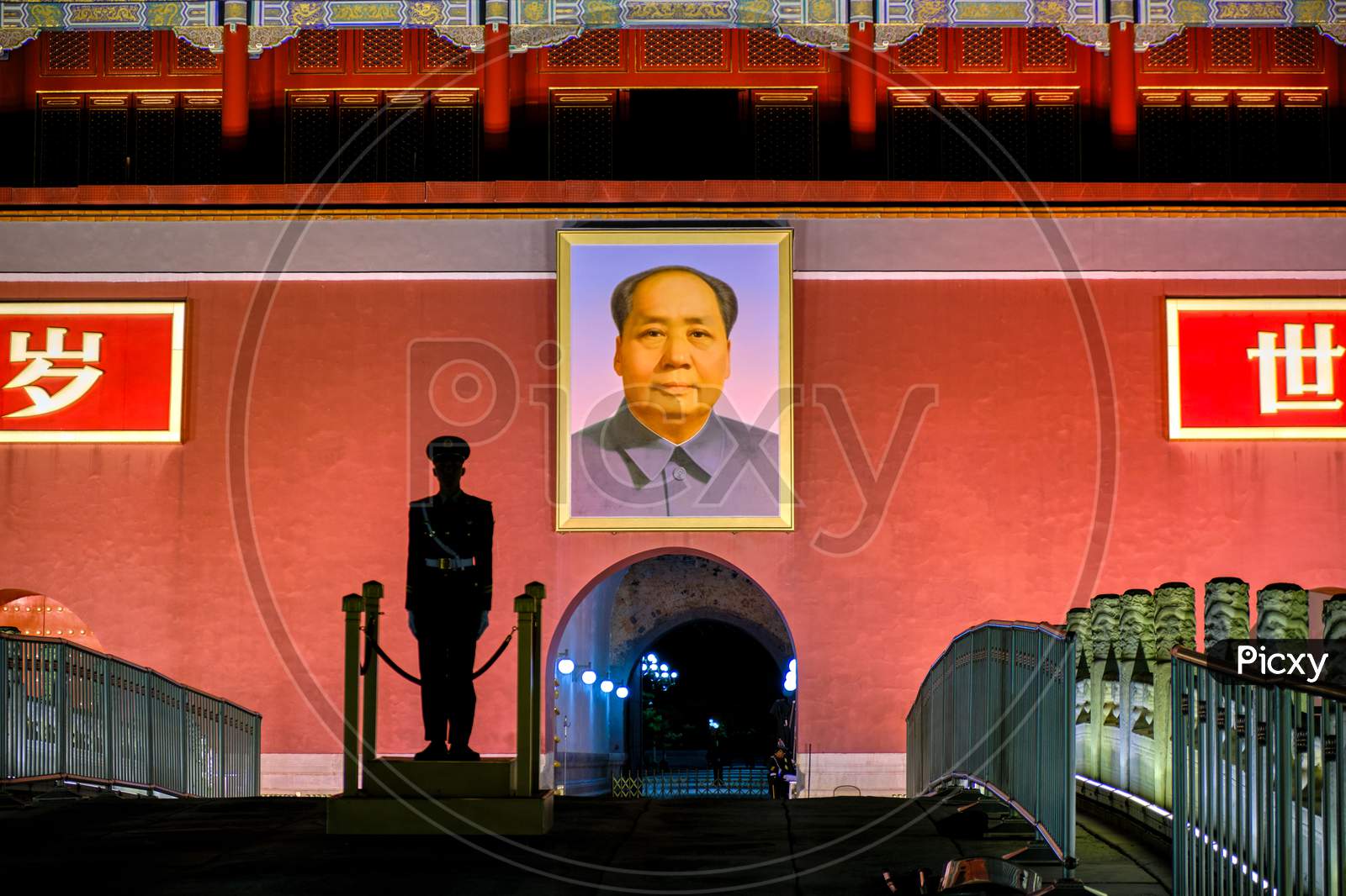 Silhouette Of A Chinese Soldier Standing Guard In Front Of The Portrait Of Mao Zedong At Tiananmen Square In Beijing, China