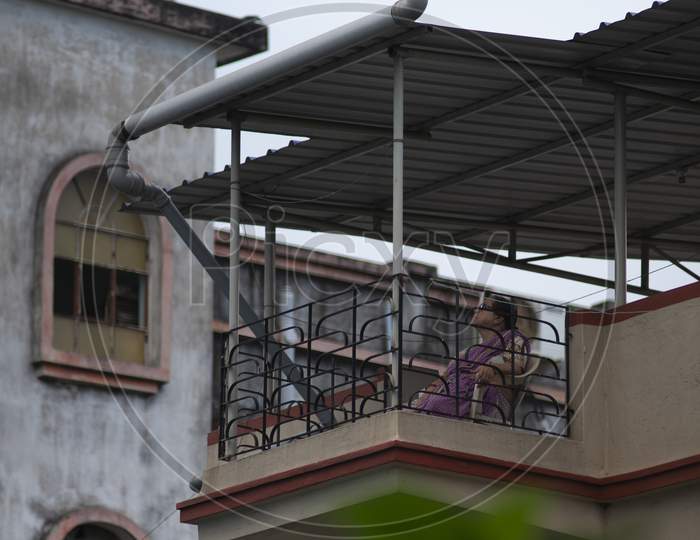 old lady sitting on balcony