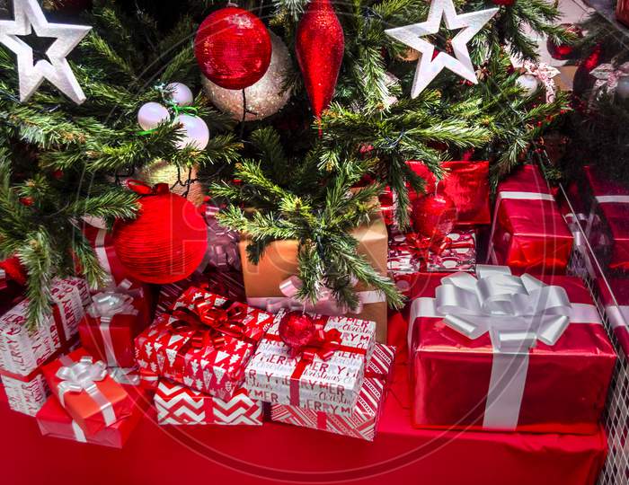 Christmas presents underneath a Christmas tree