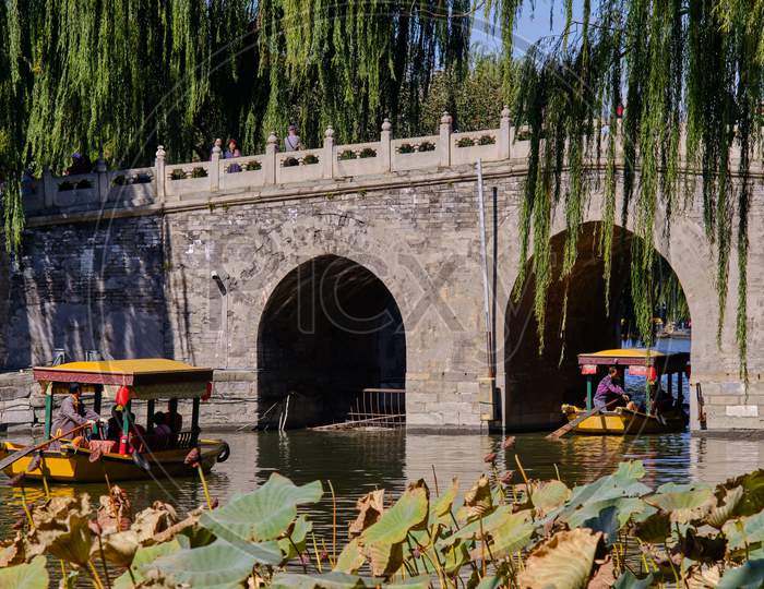 People Enjoying Boat Ride In Old Imperial Gardens Of Beihai Lake, Beihai Park In Beijing