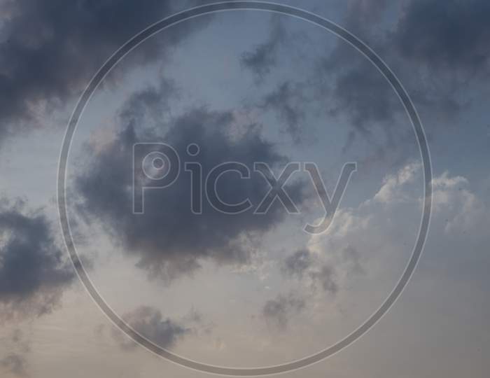 Beautiful clouds roaming in the red and bluish sky during sunset in the afternoon. Indian landscape and sky.