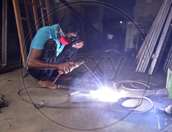 A welder works at his workshop  that was opened as per the relaxed Covid-19 or Coronavirus Nationwide Lockdown Guidelines, In Nagaon District Of Assam On  May 5, 2020.