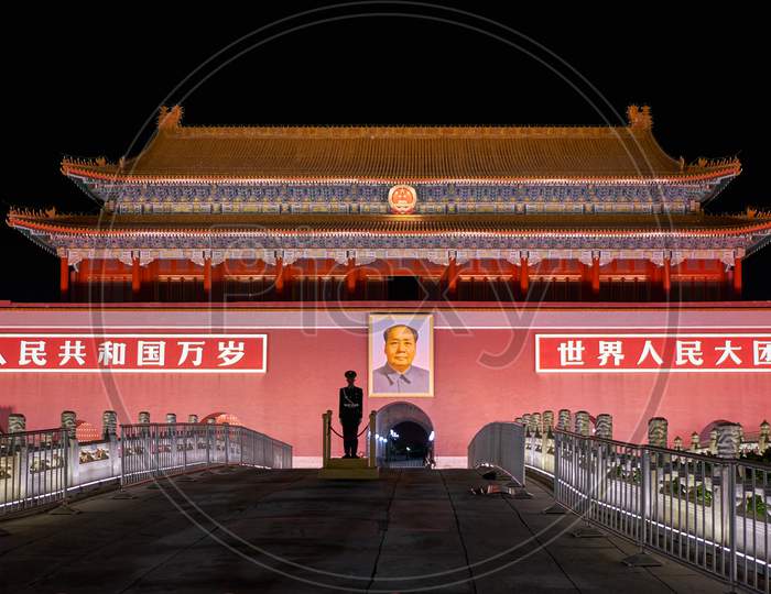 Chinese Soldier Standing Guard In Front Of The Portrait Of Mao Zedong At Tiananmen Square In Beijing, China