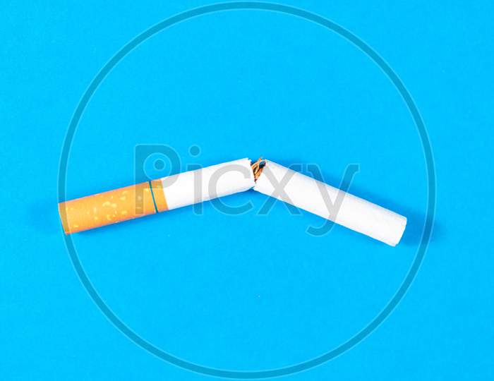Tobacco Cigarette Broken Close Up With Blue Background