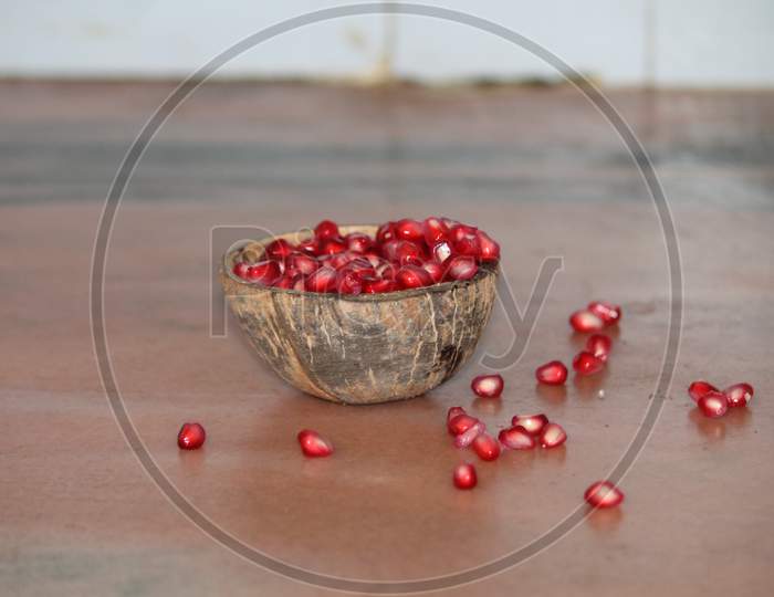 pomegranate in recycled coconut bowl