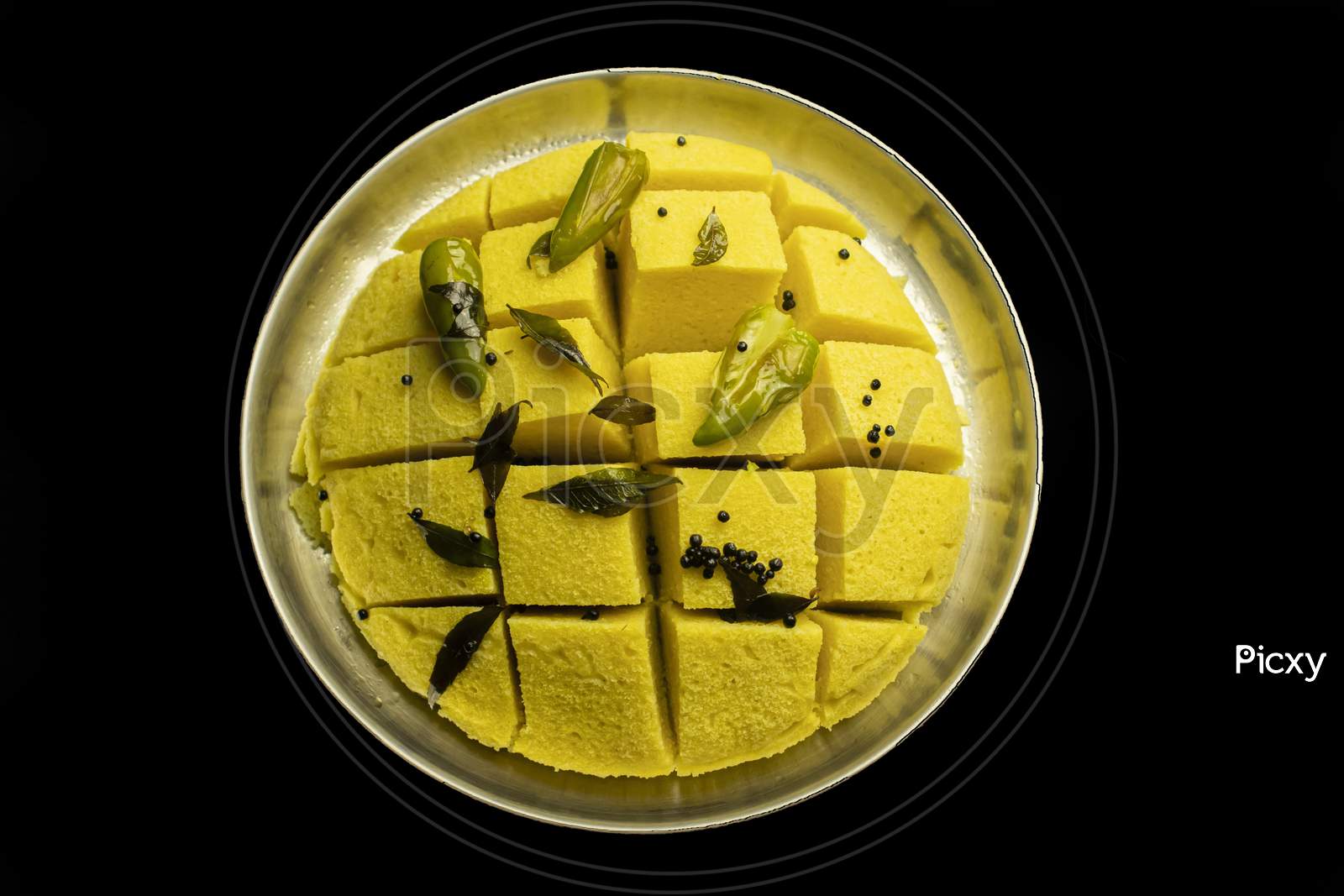 Slices Of Besan Dhokla An Indian Gujrati Vegetarian Food On Plate With Black Background