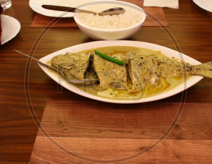 Cooked Hilsa Fish served with steamed rice in a restaurant