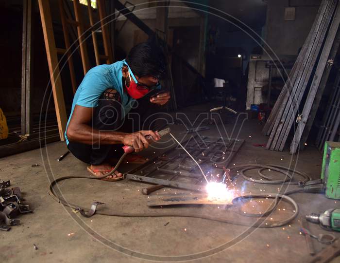 AA welder works at his workshop  that was opened as per the relaxed Covid-19 or Coronavirus Nationwide Lockdown Guidelines, In Nagaon District Of Assam On  May 5, 2020.