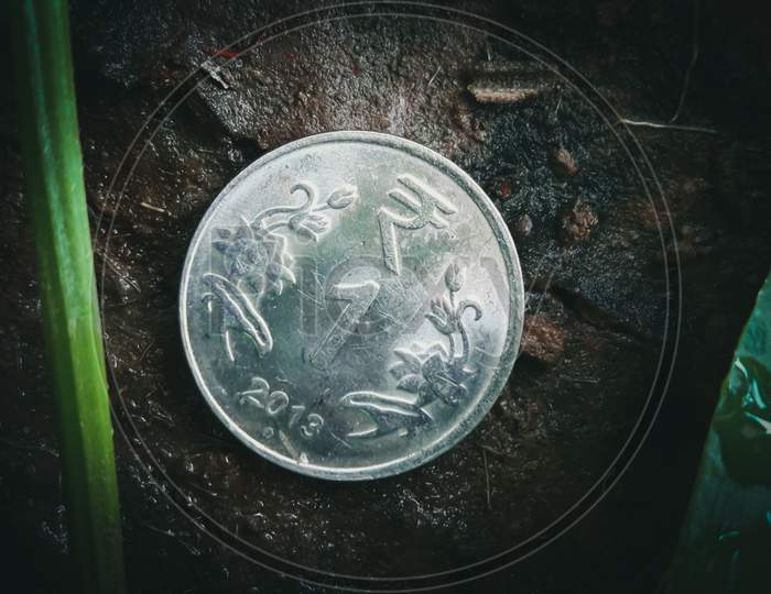 Shining 1 Rupee Coin In The Soil With Dust