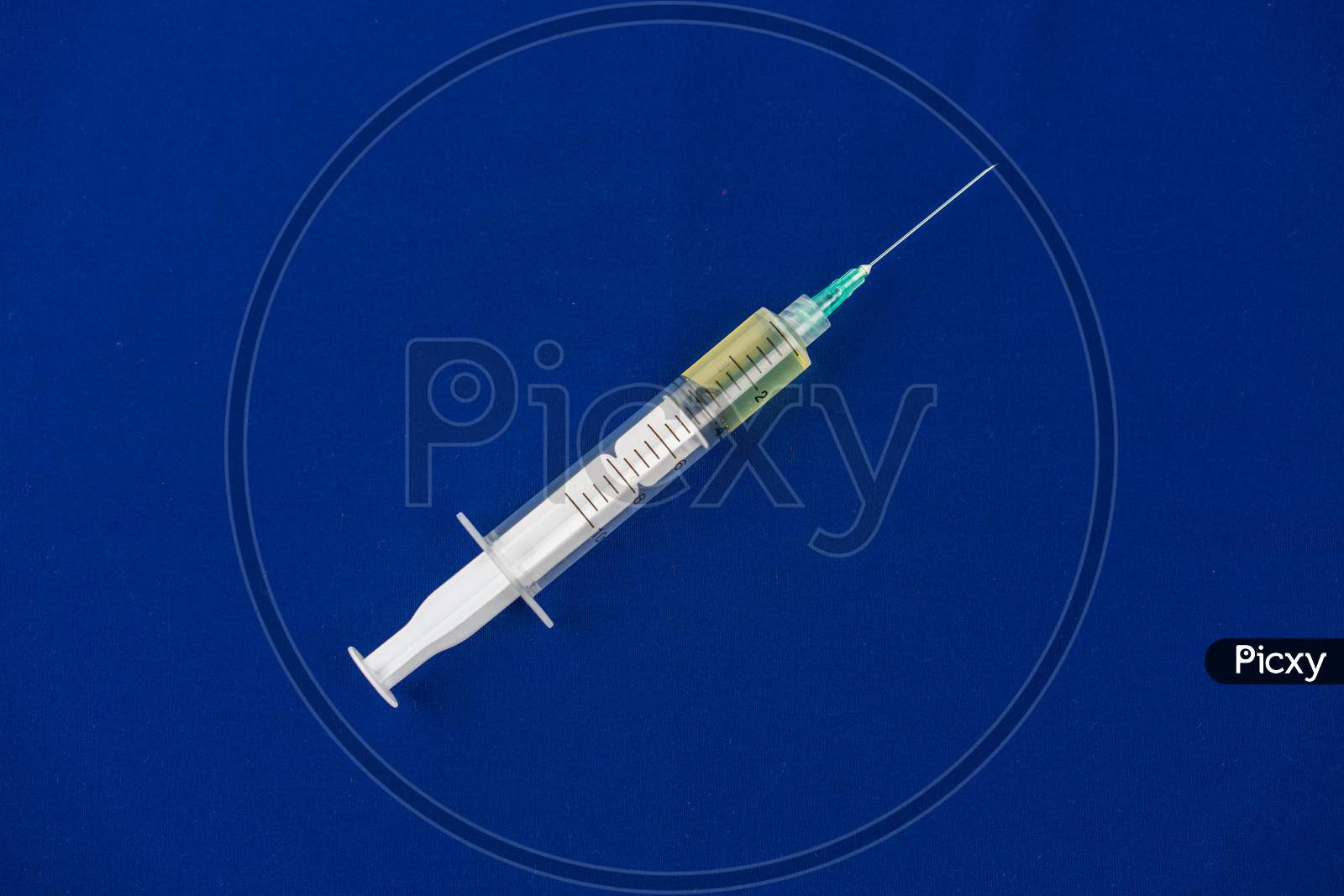 Syringe Closeup Isolated On Blue Background