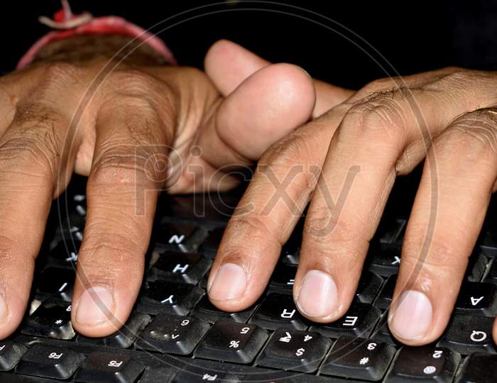 Hands Typing On A Black Keyboard