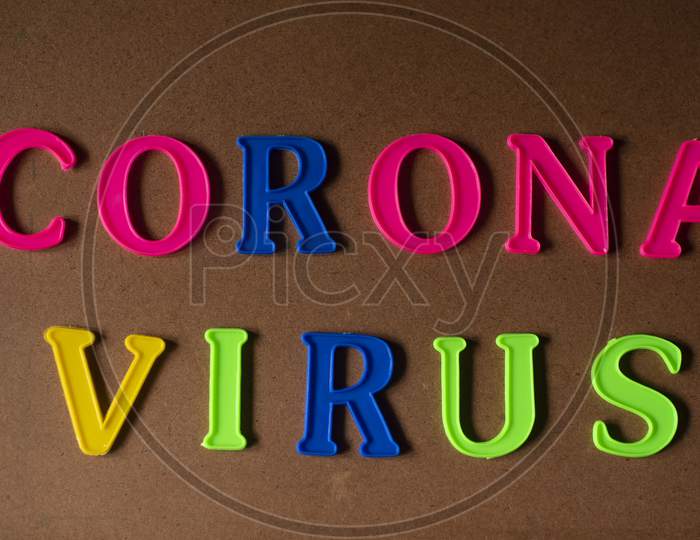'Corona virus' written on a brown wooden background