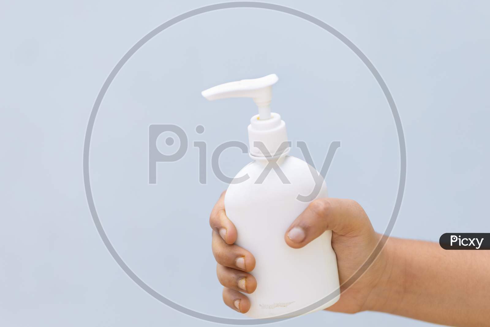 Child'S Hand With Disinfectant Hand Sanitizer Against Plain Background