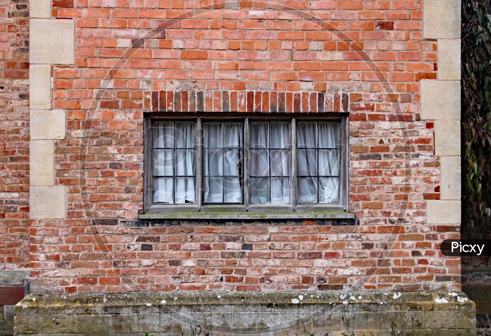 Old Wooden Window In A Weathered Brick Wall In An Old Manor House
