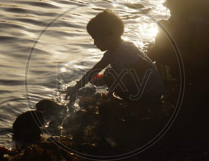 Backlight Image of Child playing in Water