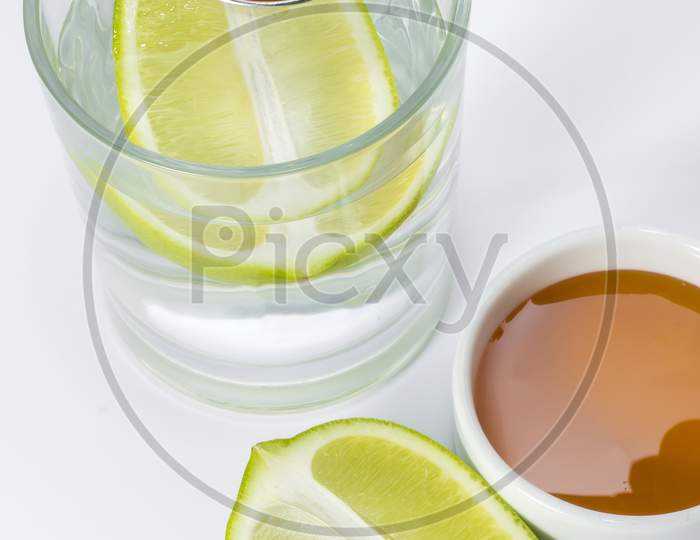 Glass of warm water with lemon and honey.